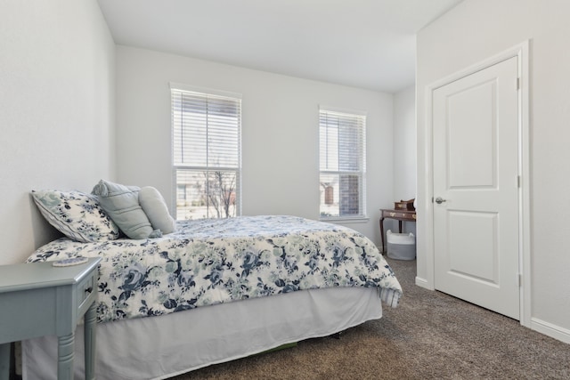 carpeted bedroom featuring multiple windows