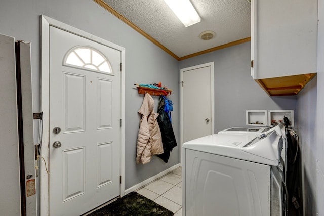 laundry room featuring washing machine and clothes dryer, crown molding, cabinets, a textured ceiling, and light tile patterned floors