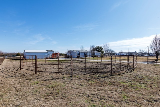 view of play area featuring an outdoor structure and a rural view