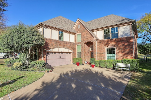 view of front of property featuring a garage and a front yard