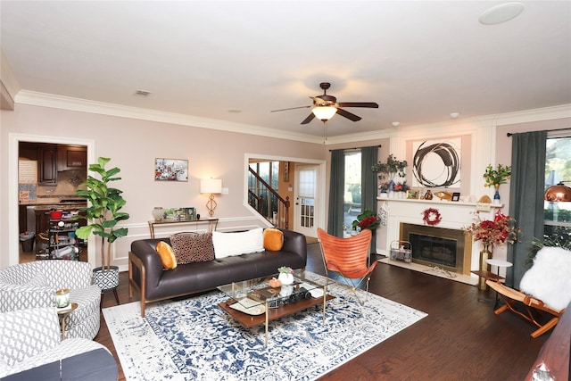 living room with ornamental molding, wood-type flooring, and a wealth of natural light