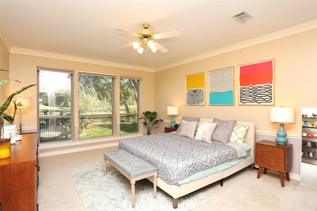 carpeted bedroom with crown molding and ceiling fan