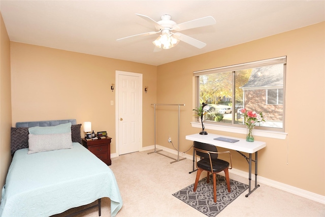 bedroom featuring light colored carpet and ceiling fan