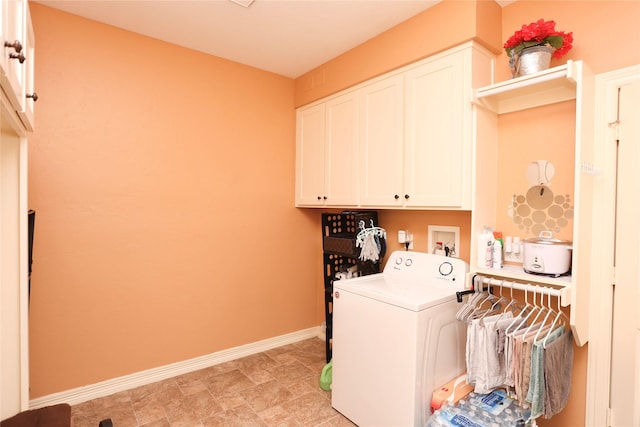 clothes washing area featuring washer / dryer and cabinets