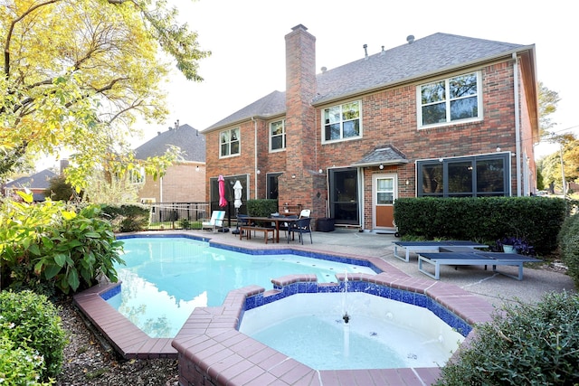 view of swimming pool with an in ground hot tub and a patio