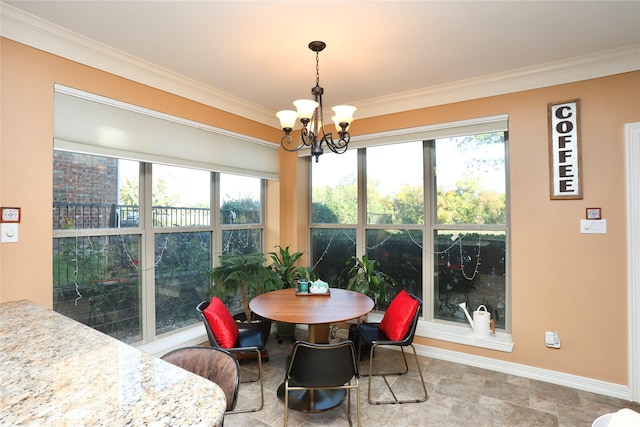 dining space with crown molding and a notable chandelier