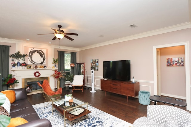 living room with crown molding, ceiling fan, and dark hardwood / wood-style floors