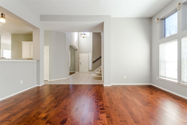 empty room featuring an inviting chandelier and light hardwood / wood-style flooring