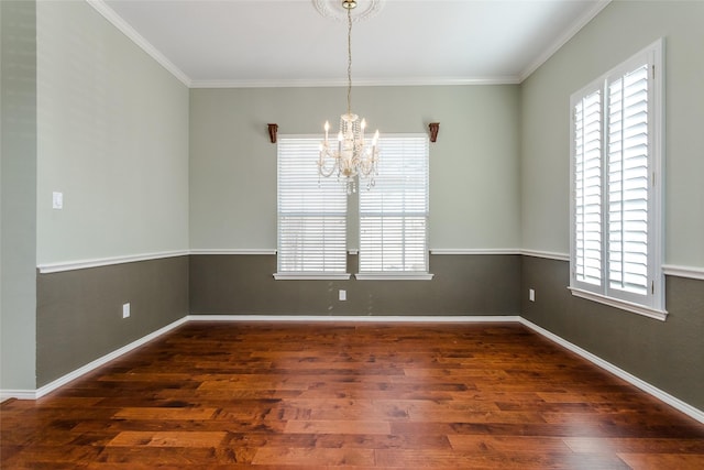 spare room featuring crown molding, plenty of natural light, a chandelier, and dark hardwood / wood-style flooring