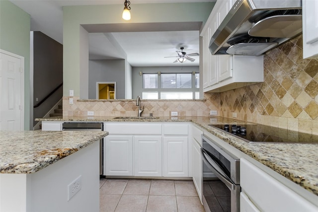 kitchen with extractor fan, appliances with stainless steel finishes, sink, and white cabinets