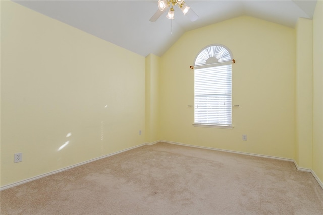 carpeted spare room featuring ceiling fan and lofted ceiling