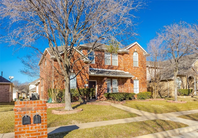 view of front of home with brick siding, roof with shingles, and a front lawn