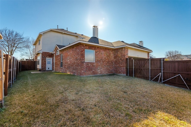 back of house with a lawn