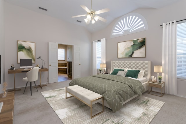 carpeted bedroom featuring high vaulted ceiling, connected bathroom, and ceiling fan