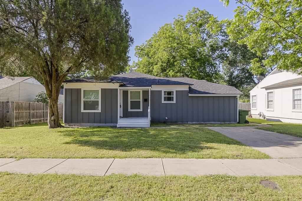 1406 Resistol Rd, Garland, TX 75042 - view of front of home with board and batten siding and a shingled roof