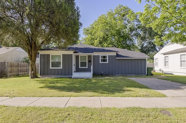 1406 Resistol Rd, Garland, TX 75042 - view of front of home with board and batten siding and a shingled roof