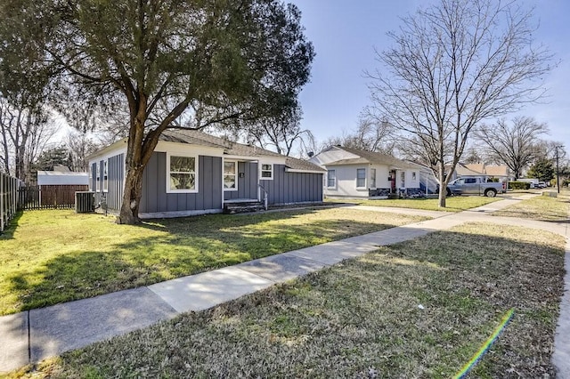 ranch-style house with central AC unit and a front yard