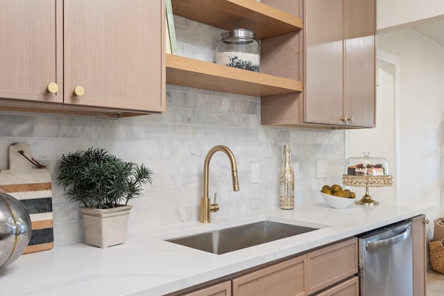 kitchen featuring dishwasher, sink, backsplash, and light brown cabinetry