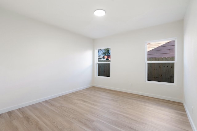 spare room with light hardwood / wood-style flooring