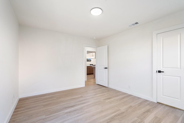 spare room featuring light wood-type flooring