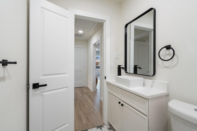 bathroom featuring vanity, toilet, and wood-type flooring