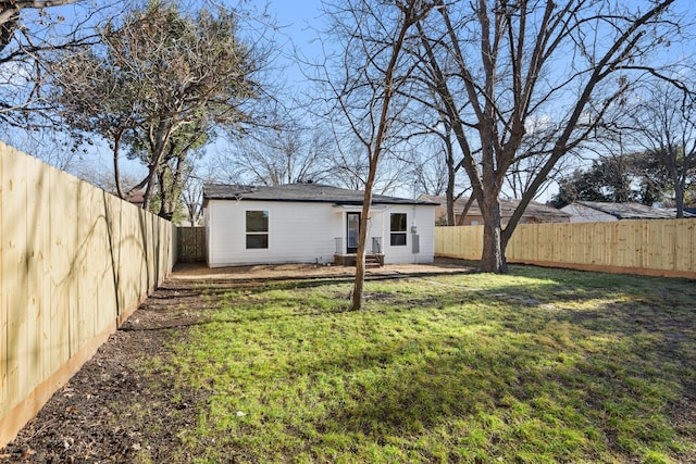 rear view of house featuring a lawn