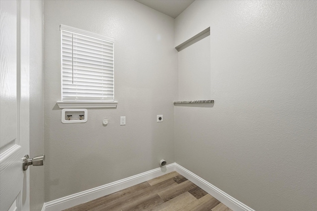 washroom with hardwood / wood-style flooring, gas dryer hookup, hookup for a washing machine, and hookup for an electric dryer