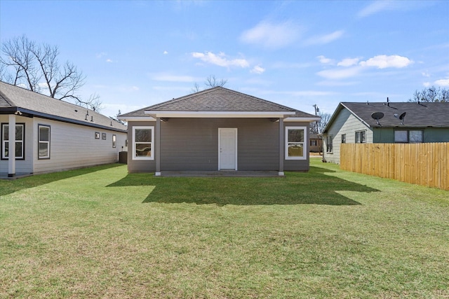 back of house featuring a yard