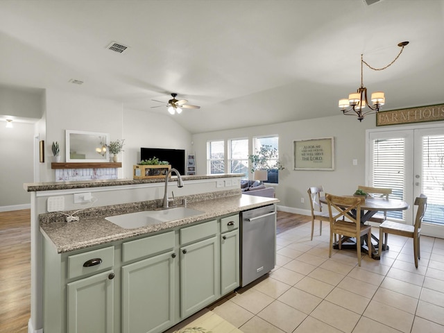 kitchen with light tile patterned floors, sink, dishwasher, hanging light fixtures, and ceiling fan with notable chandelier