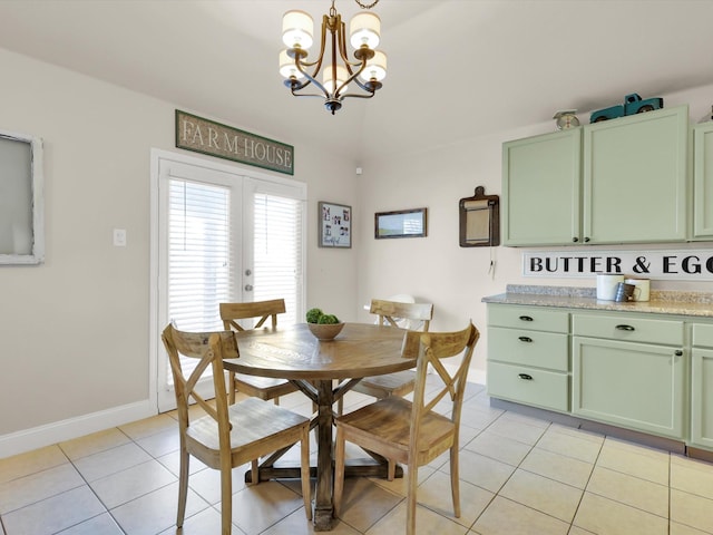 tiled dining space featuring french doors and a chandelier