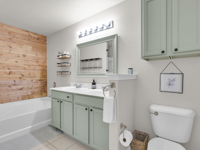 bathroom featuring tile patterned floors, toilet, vanity, wooden walls, and a tub