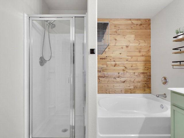 bathroom featuring vanity, wooden walls, and shower with separate bathtub