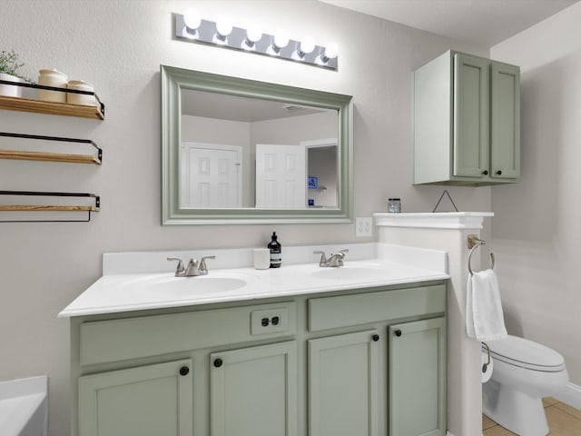 bathroom with tile patterned floors, vanity, and toilet