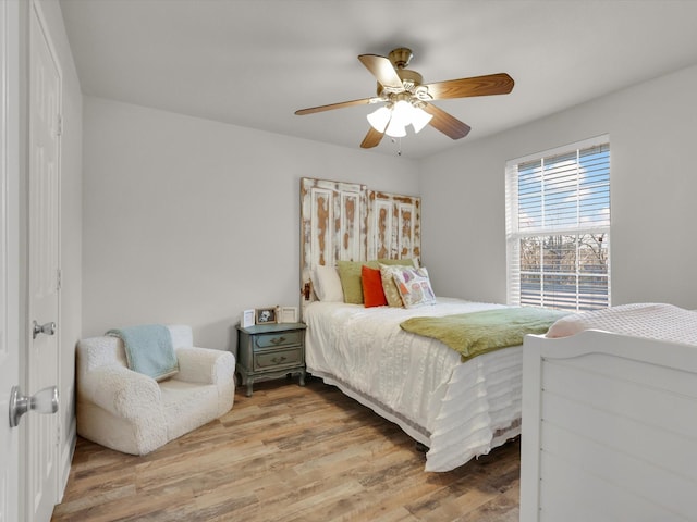 bedroom with ceiling fan and hardwood / wood-style floors