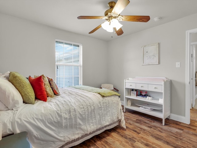 bedroom with ceiling fan and hardwood / wood-style floors