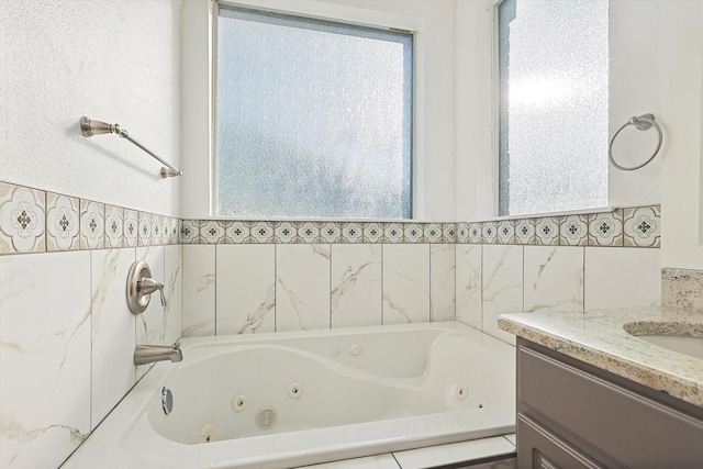 bathroom with vanity and a washtub