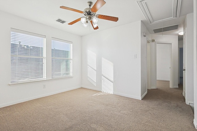 empty room featuring light colored carpet and ceiling fan