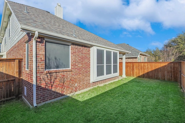 rear view of property with a yard