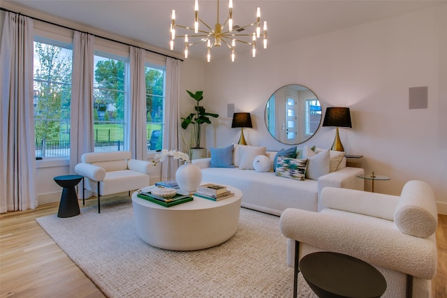 living room featuring hardwood / wood-style flooring and an inviting chandelier