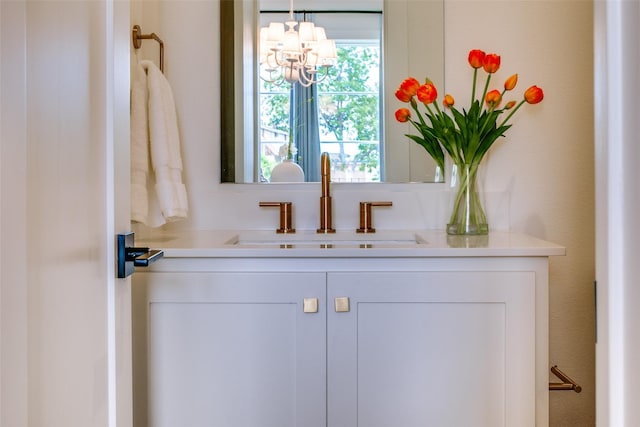 bathroom featuring vanity and a chandelier