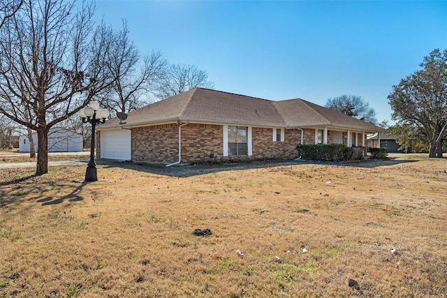 single story home featuring a garage and a front yard