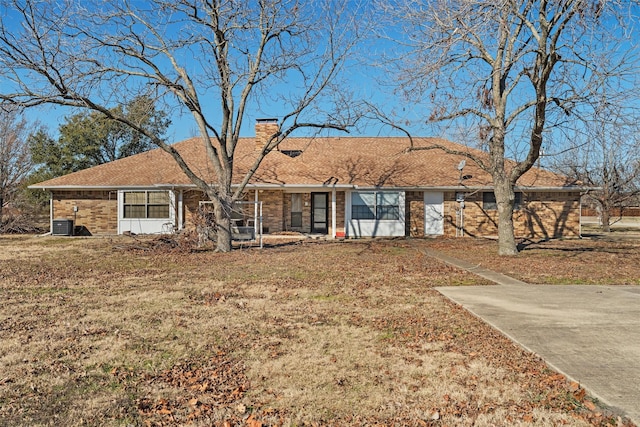 single story home with central AC and a front yard