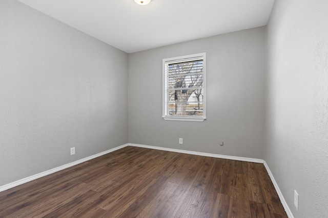 empty room featuring dark wood-type flooring