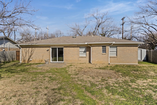 back of house with a lawn