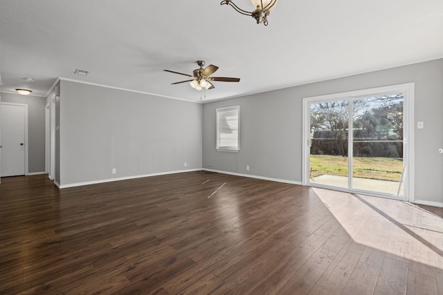 spare room with crown molding, dark wood-type flooring, and ceiling fan