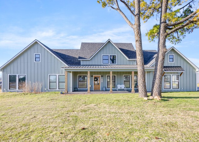 back of house with a yard and a porch