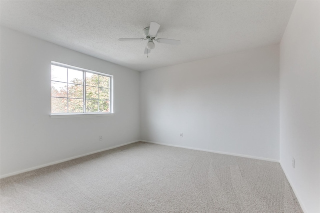 carpeted spare room with ceiling fan and a textured ceiling