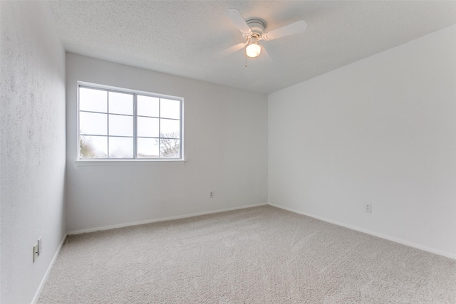 unfurnished room featuring carpet floors, a textured ceiling, and ceiling fan