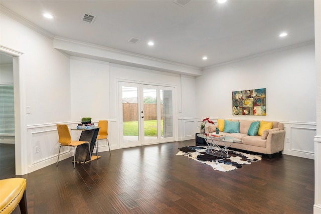 living room with crown molding, dark hardwood / wood-style flooring, and french doors