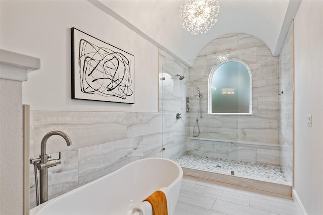 bathroom featuring a chandelier and independent shower and bath